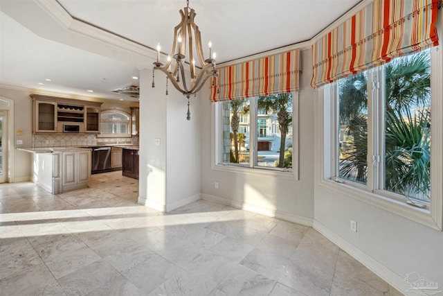 unfurnished dining area featuring crown molding and a notable chandelier