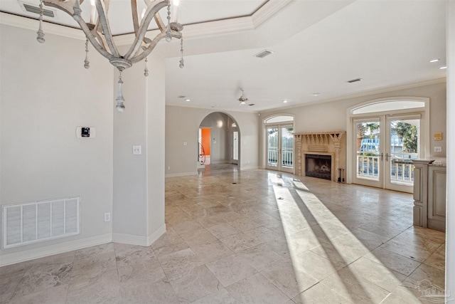 unfurnished living room featuring crown molding and french doors