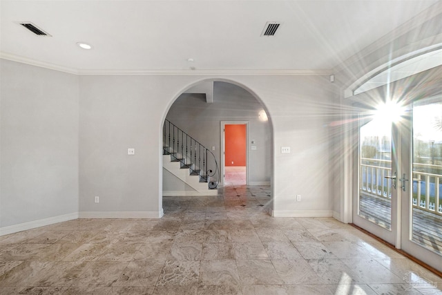 spare room with crown molding and a wealth of natural light