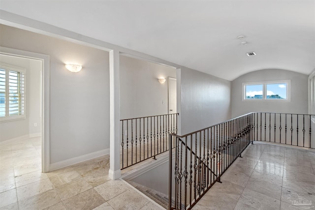 hallway with lofted ceiling