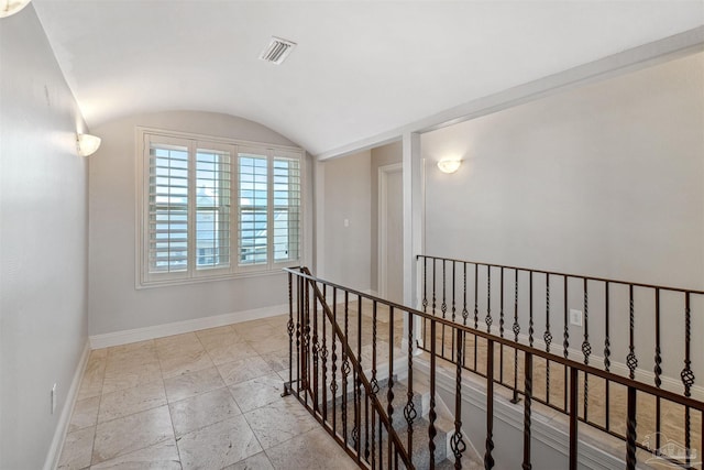 hallway featuring vaulted ceiling