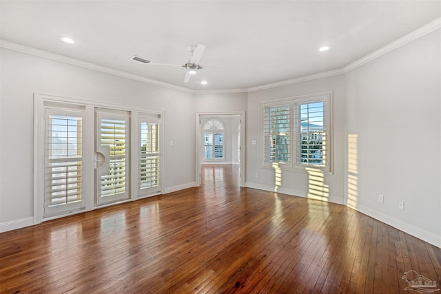 unfurnished living room with crown molding, ceiling fan, wood-type flooring, and a wealth of natural light