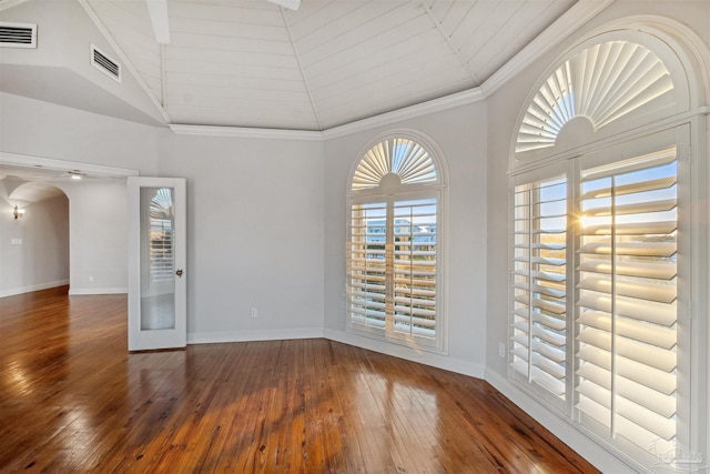 unfurnished room featuring crown molding, dark wood-type flooring, and high vaulted ceiling