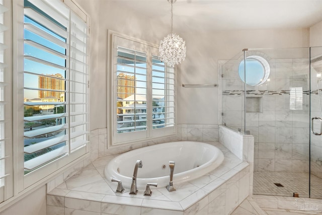 bathroom featuring shower with separate bathtub and a chandelier