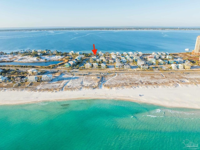 drone / aerial view with a water view and a beach view