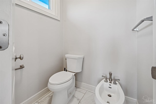 bathroom featuring a bidet and toilet