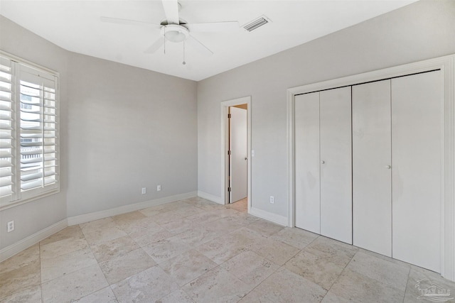 unfurnished bedroom featuring a closet and ceiling fan