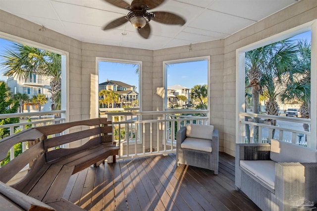 sunroom featuring ceiling fan