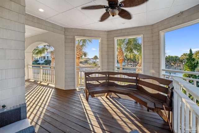 interior space with ceiling fan