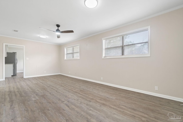 unfurnished room featuring ornamental molding, wood-type flooring, and ceiling fan