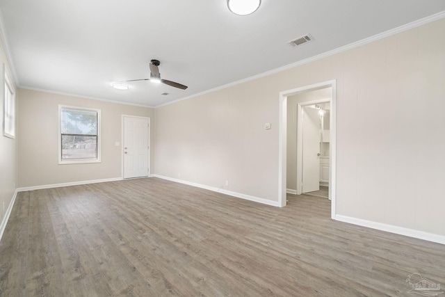 spare room featuring crown molding, ceiling fan, and light hardwood / wood-style floors