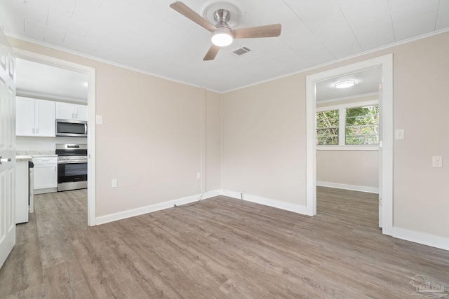 unfurnished room with ornamental molding, ceiling fan, and light wood-type flooring