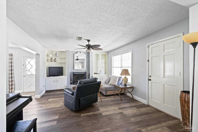 941 Summer Shade Ln, Cantonment, FL 32533 - living area with a ceiling fan, dark wood-style flooring, baseboards, a textured ceiling, and a brick fireplace