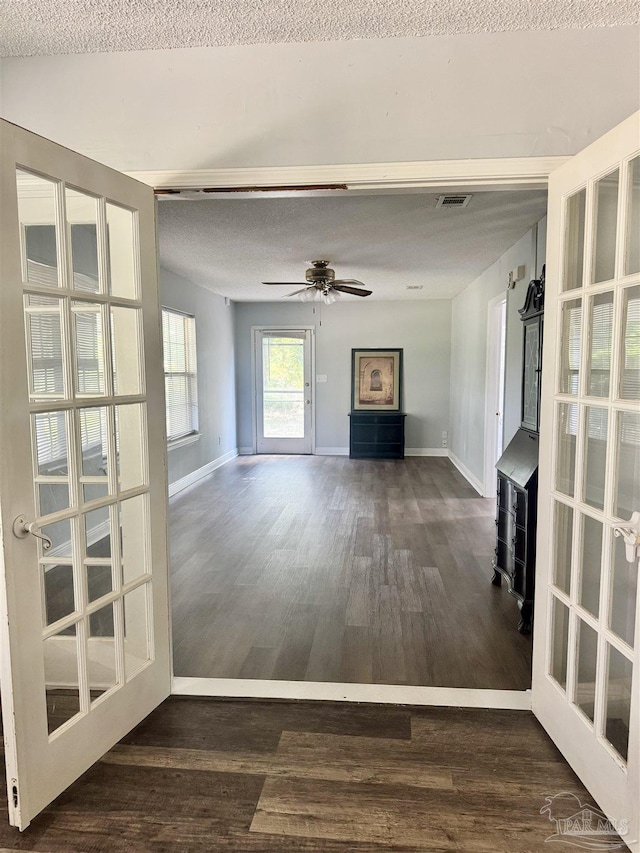 941 Summer Shade Ln, Cantonment, FL 32533 - unfurnished living room with wood finished floors, baseboards, ceiling fan, and a textured ceiling