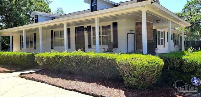 view of side of home with covered porch