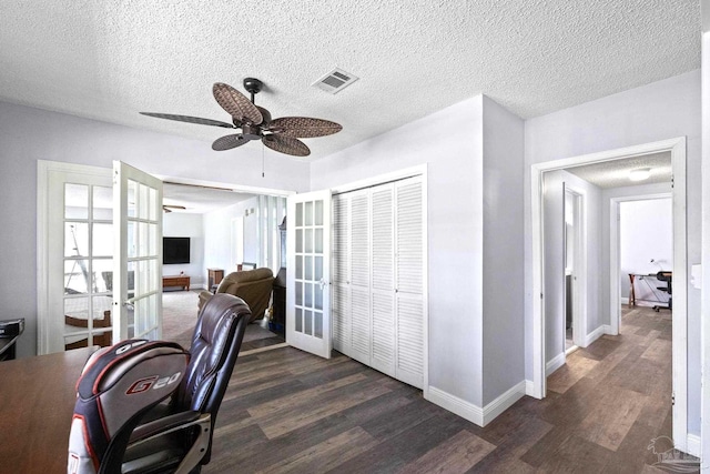 office area featuring a textured ceiling, ceiling fan, french doors, and dark hardwood / wood-style floors