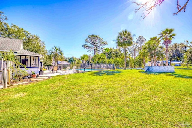 view of yard with a fenced in pool and a patio area