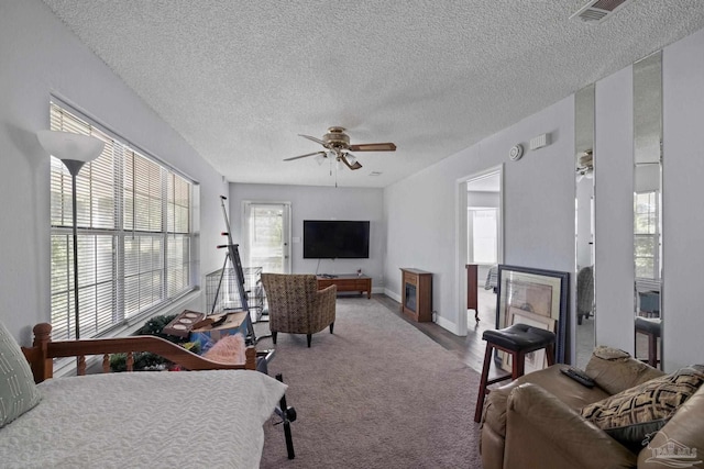 941 Summer Shade Ln, Cantonment, FL 32533 - living room with a textured ceiling, ceiling fan, carpet floors, and baseboards