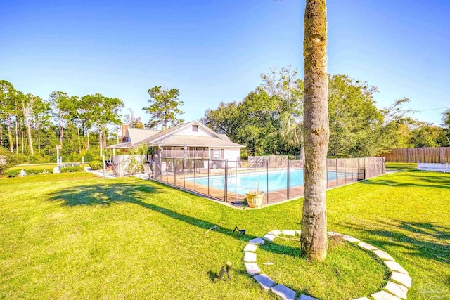 view of pool featuring a lawn