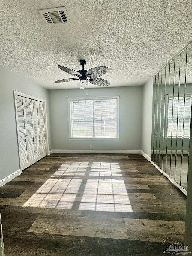 941 Summer Shade Ln, Cantonment, FL 32533 - unfurnished bedroom featuring wood finished floors, a closet, baseboards, and a textured ceiling