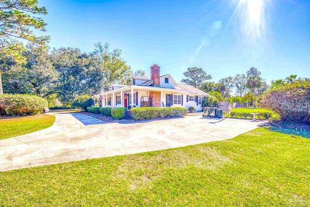 941 Summer Shade Ln, Cantonment, FL 32533 - view of front of home with a front lawn and a chimney