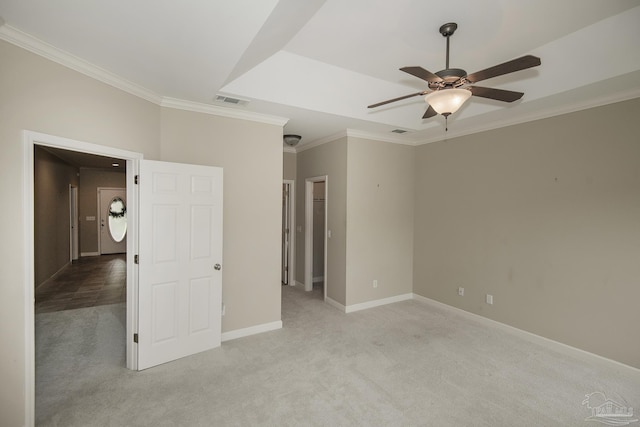 3200 Silverleaf Dr, Pensacola, FL 32504 - unfurnished bedroom with light colored carpet, crown molding, a walk in closet, baseboards, and a ceiling fan