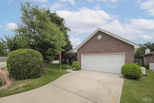 3200 Silverleaf Dr, Pensacola, FL 32504 - view of side of home featuring brick siding, a garage, a lawn, and driveway
