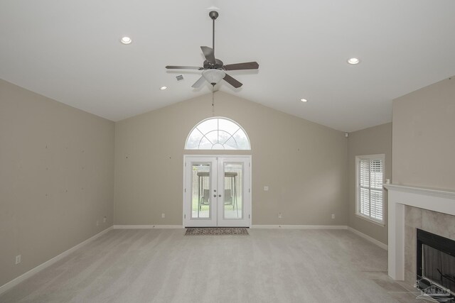 3200 Silverleaf Dr, Pensacola, FL 32504 - unfurnished living room featuring plenty of natural light, light carpet, a ceiling fan, a tiled fireplace, and lofted ceiling
