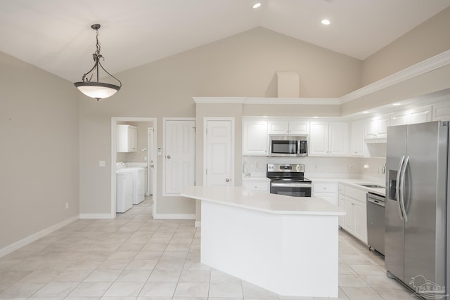 3200 Silverleaf Dr, Pensacola, FL 32504 - kitchen featuring stainless steel appliances, washer and dryer, a sink, light countertops, and high vaulted ceiling