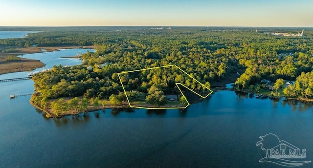 aerial view at dusk featuring a water view