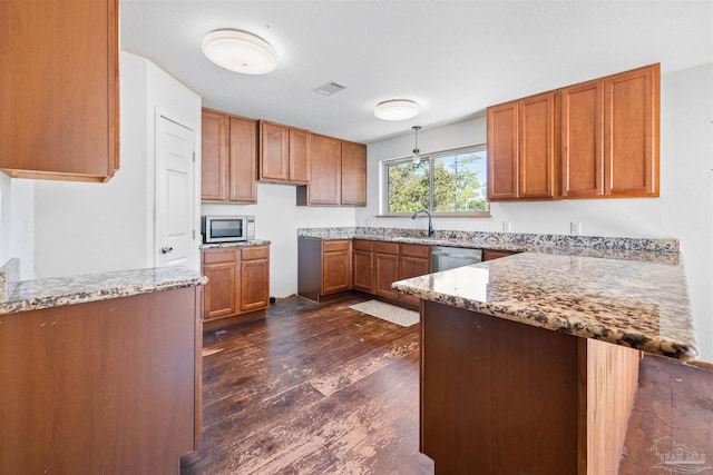 kitchen featuring light stone countertops, dark hardwood / wood-style flooring, sink, and appliances with stainless steel finishes