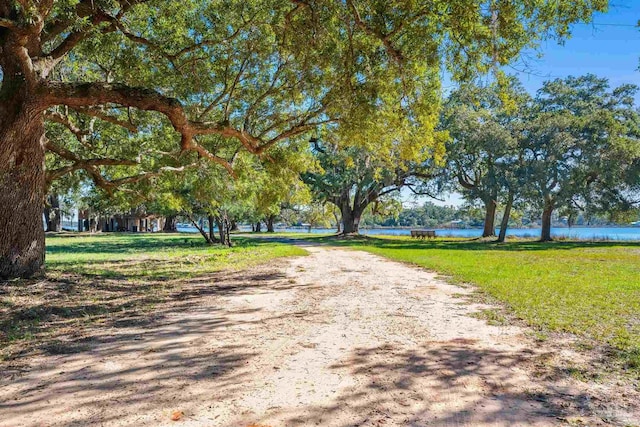 surrounding community featuring a yard and a water view