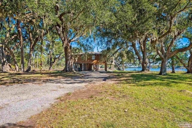 view of front of property with a carport and a front yard