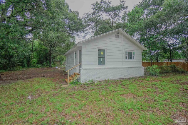 view of side of home featuring a yard