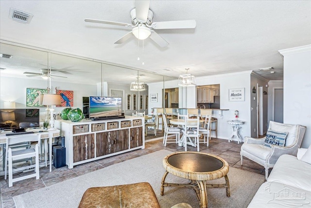 tiled living room featuring a ceiling fan, visible vents, ornamental molding, and a textured ceiling