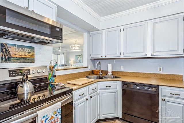 kitchen with white cabinets, stainless steel appliances, crown molding, light countertops, and a sink