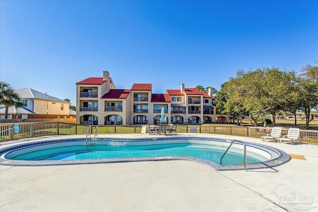 pool featuring a patio area and fence