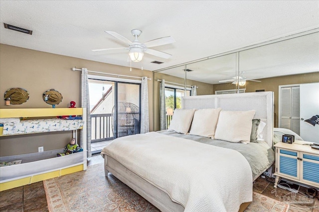 bedroom with access to exterior, ceiling fan, visible vents, and a textured ceiling