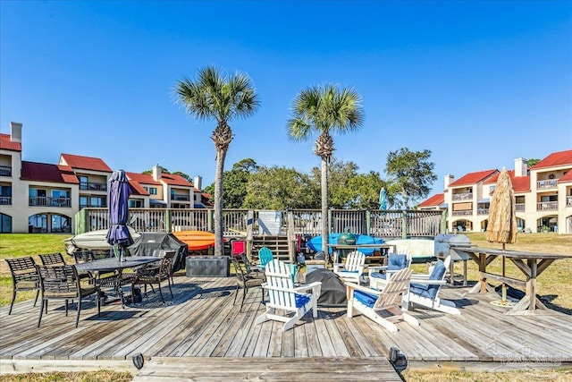 dock area with a fire pit and a wooden deck