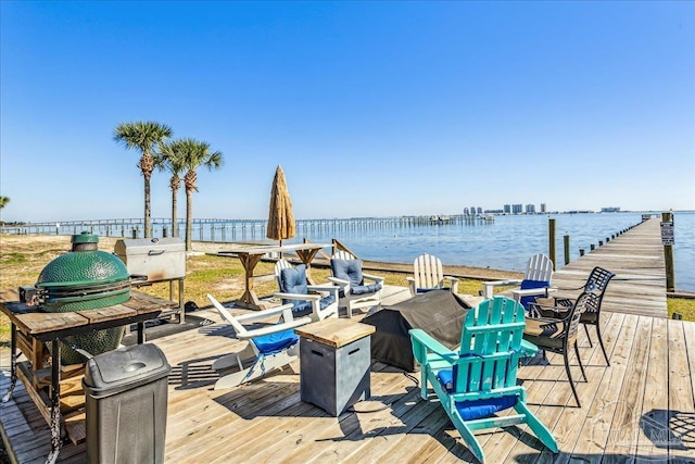 wooden deck featuring a dock and a water view