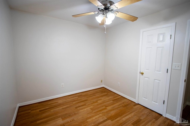 empty room with ceiling fan and light hardwood / wood-style flooring