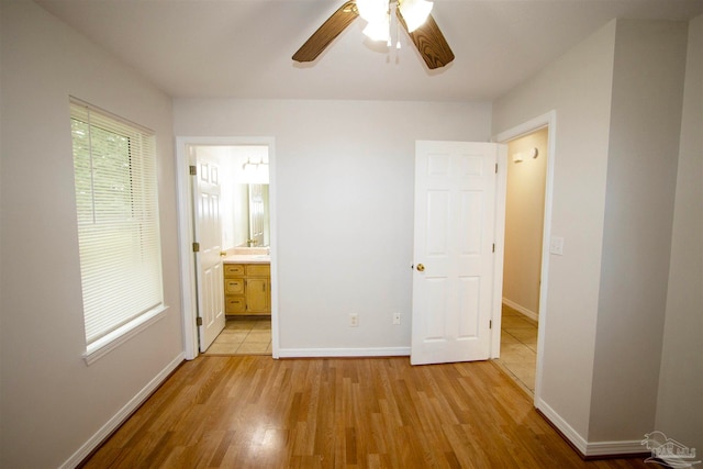 unfurnished bedroom featuring ceiling fan, light hardwood / wood-style floors, and ensuite bathroom