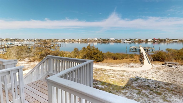 wooden terrace featuring a water view and a boat dock