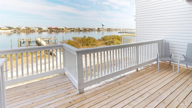 deck with a dock and a water view