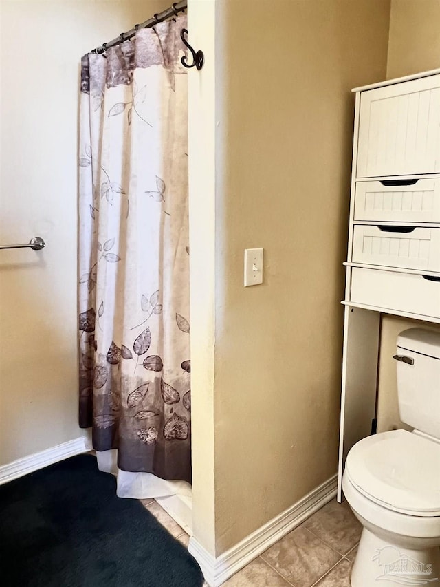 bathroom featuring tile patterned flooring and toilet