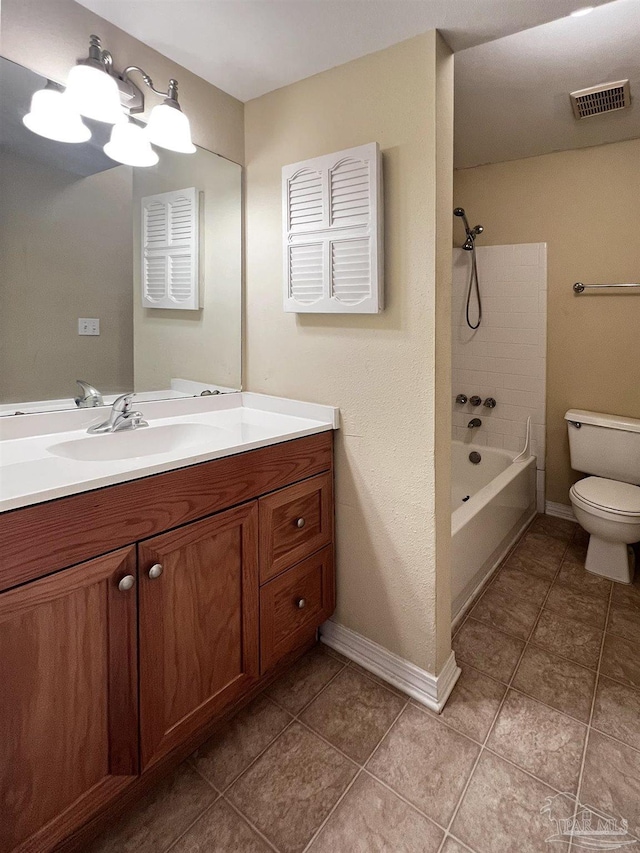 full bathroom featuring tiled shower / bath, vanity, toilet, and tile patterned flooring