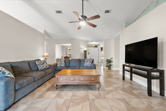 living room featuring a ceiling fan, visible vents, and vaulted ceiling