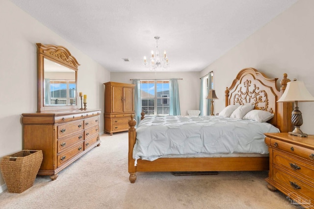 bedroom with visible vents, a chandelier, and light colored carpet