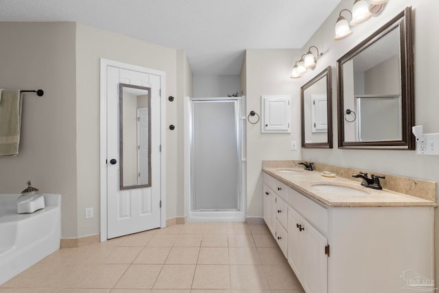 full bath featuring tile patterned floors, a sink, a bath, and a shower stall