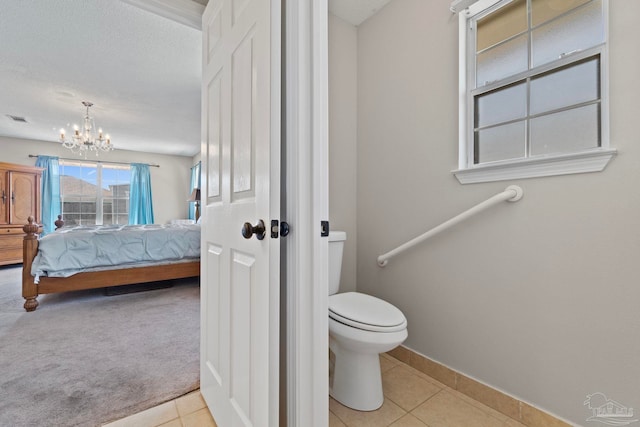 bathroom with tile patterned flooring, connected bathroom, toilet, visible vents, and baseboards